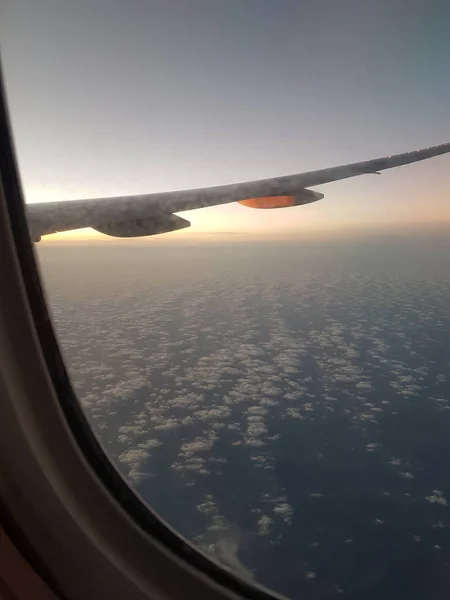 View of blue cloudy sky from airplane window