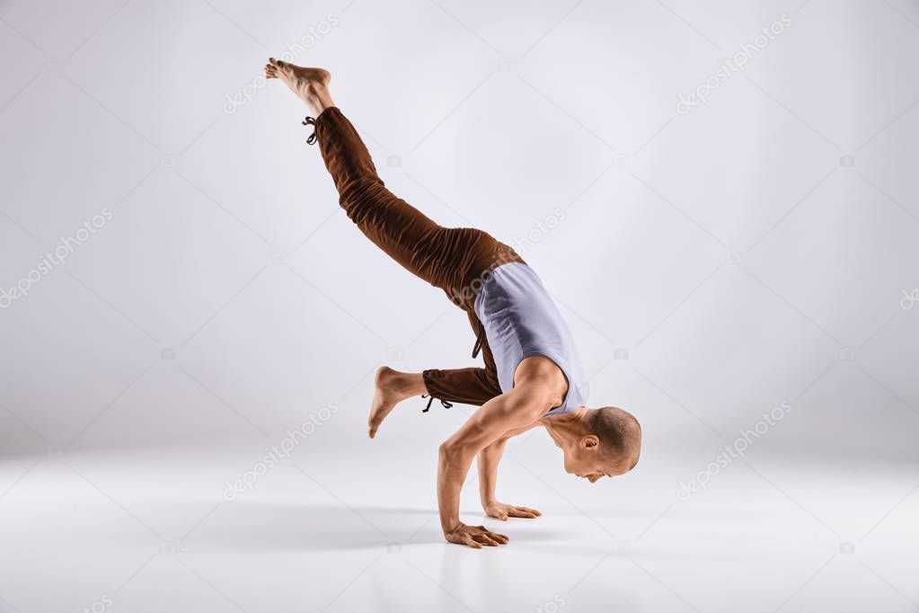 Man doing yoga isolated on white background