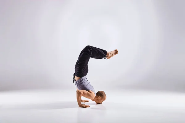 Hombre haciendo yoga aislado sobre fondo blanco — Foto de Stock