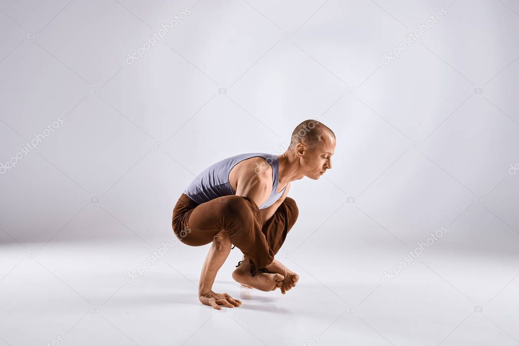 Man doing yoga isolated on white background