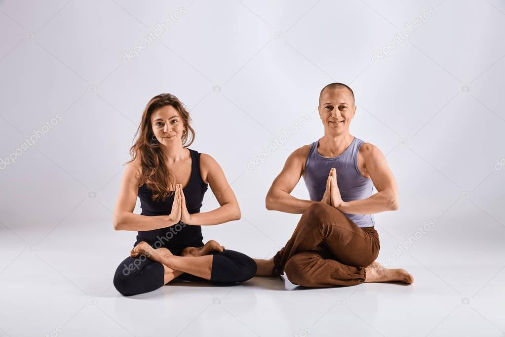 Man doing yoga isolated on white background