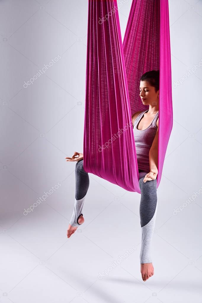 Aerial different inversion antigravity yoga in a hammock