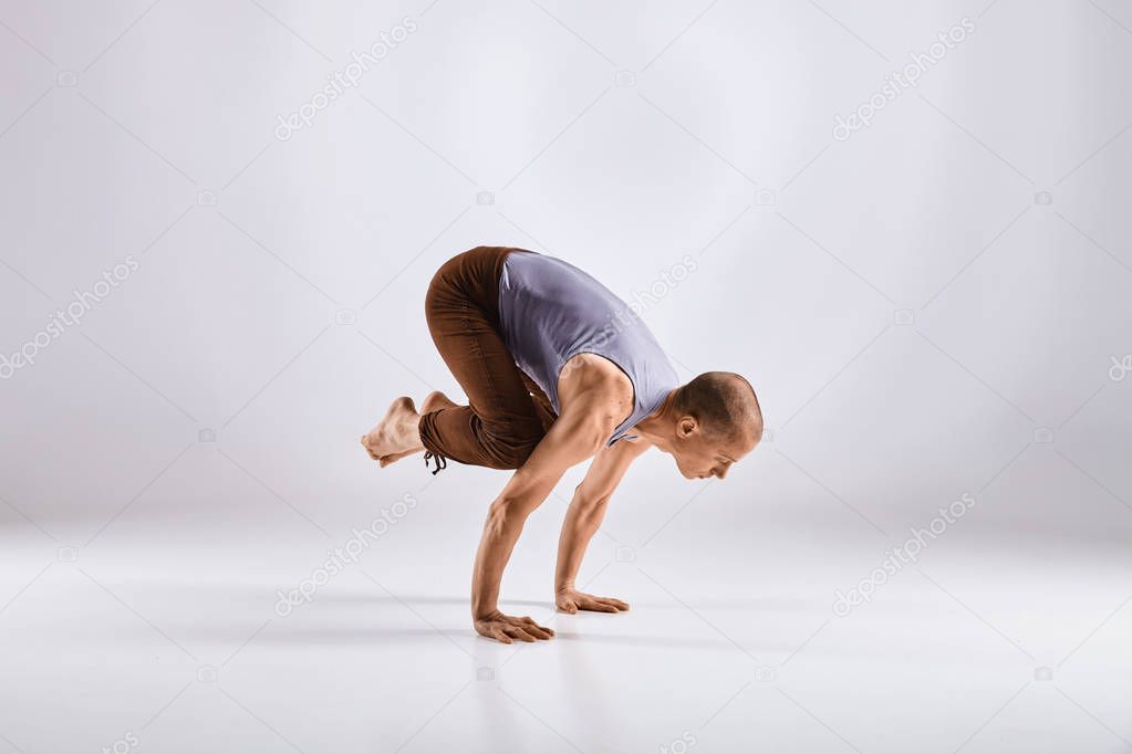 Man doing yoga isolated on white background