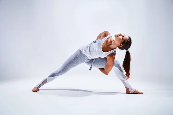 Mujer haciendo yoga aislada sobre fondo blanco —  Fotos de Stock