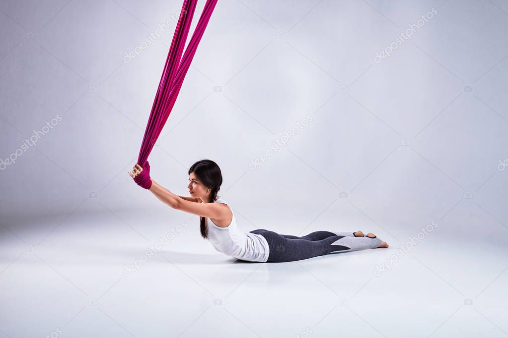 Aerial different inversion antigravity yoga in a hammock