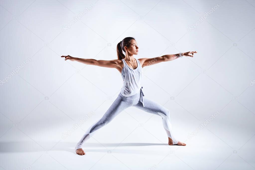 Woman doing yoga isolated on white background