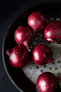 Sliced red spanish onion on vintage frying pan clipart
