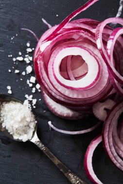 Sliced red spanish onion rings and sea salt clipart