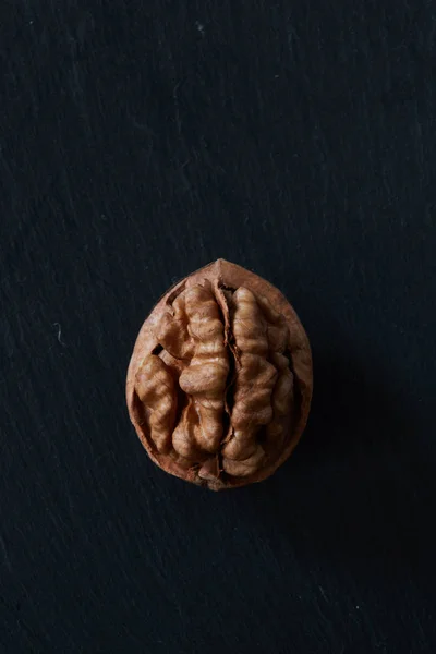 Walnut kernel on a slate backdrop — Stock Photo, Image