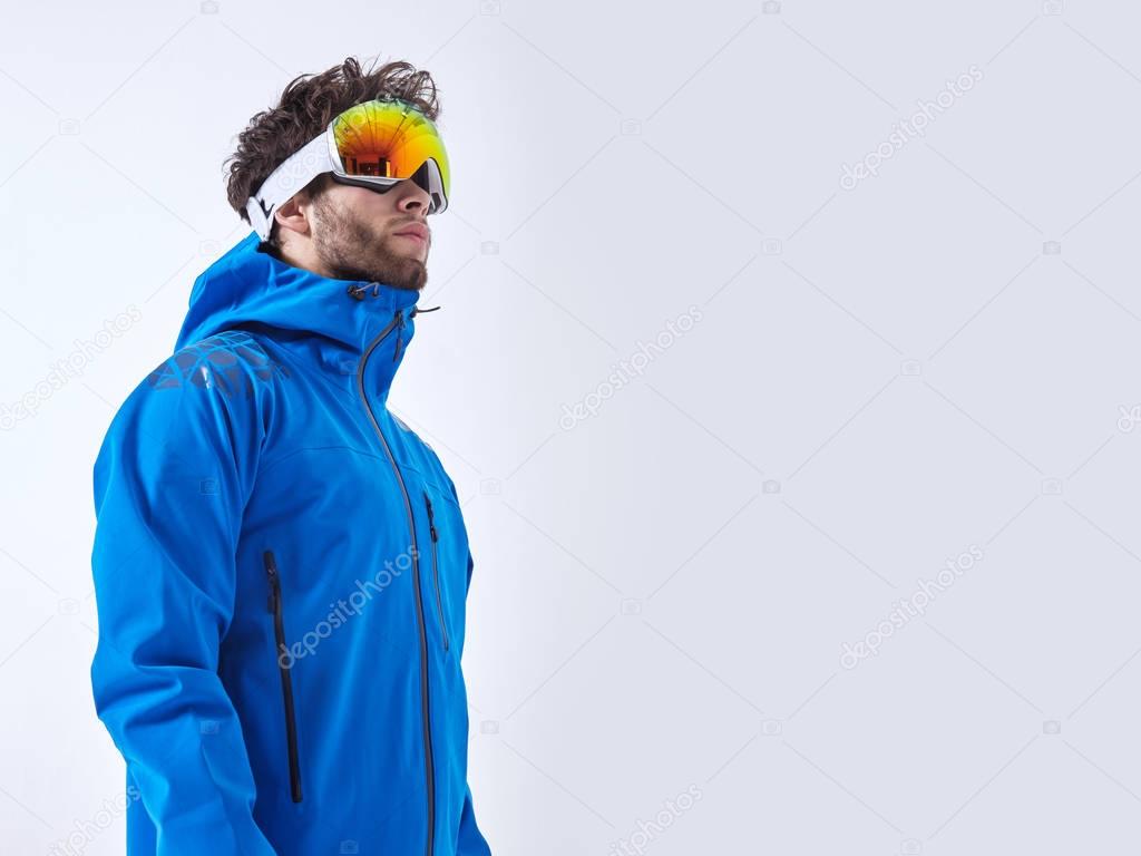 The mountaineer in winter clothes and ski ultraviolet protected mask on white isolated background