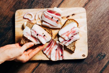 Tahtada ve elde siyah ekmek olan domuz yağı.