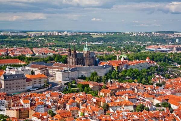 Aerial view of the city. St. Vitus Cathedral over old town red roofs. Prague, Czech Republic — Stock Photo, Image