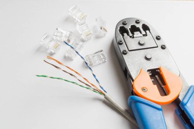 Beyaz arka plan üzerinde crimper, konektörler ve ethernet kablosu