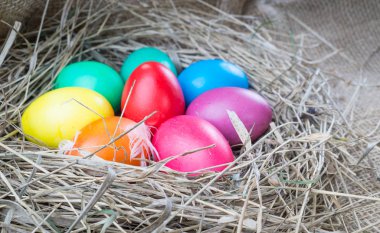 Saman çul arka plan üzerinde renkli Paskalya yumurtaları