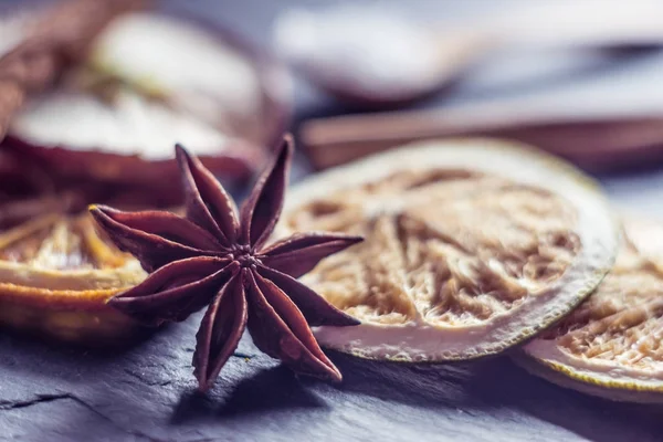 Blurred macro anise and dry orange — Stock Photo, Image