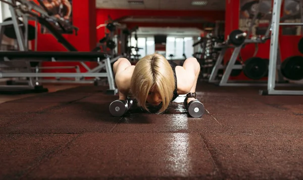 Frau in einem Fitnessstudio macht eine Reißverschlussübung — Stockfoto