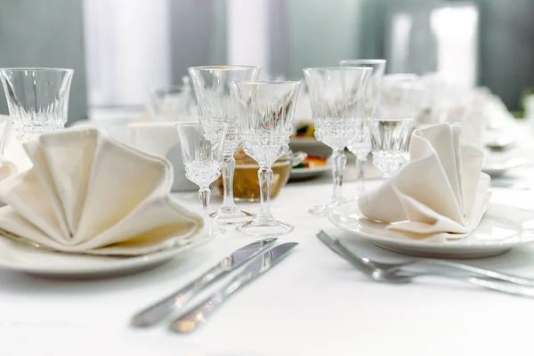 Luxury dinner set arranged on a table with vintage cream lace ta