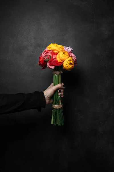 bunch of flowers in hand, on a black background, ebony, bouquet