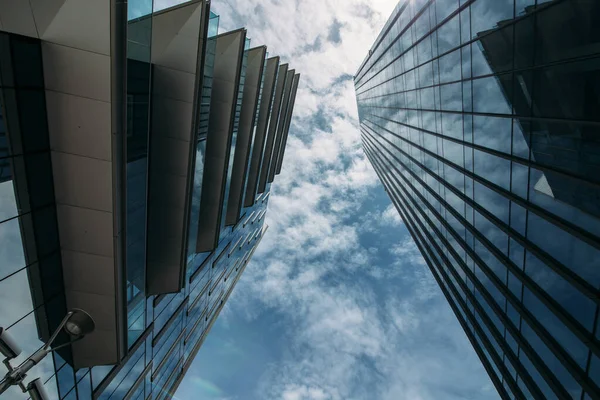 two skyscraper view from below against the sun against a blue sky