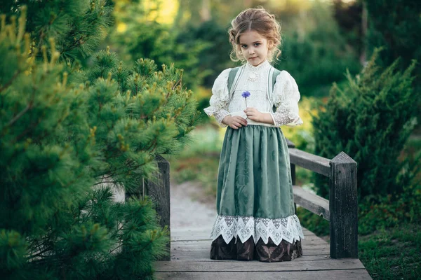 Girl Green White Dress Holds Flower Her Hands Stands Wooden — Stock Photo, Image