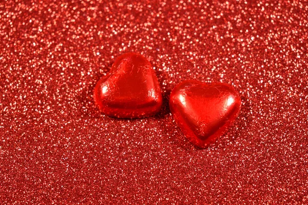 Red background with hearts stock images. Two hearts chocolate. Red hearts background. Red Valentine Day glitter background