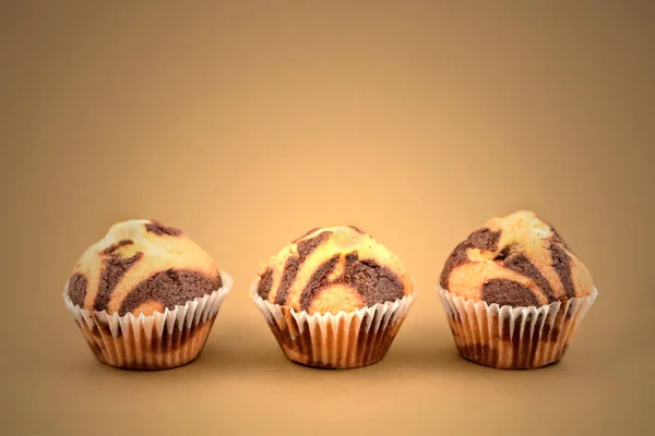 マーブル チョコレートのマフィンはストック画像です 茶色の背景にマフィン 茶色の背景に分離された つのマフィン — ストック写真