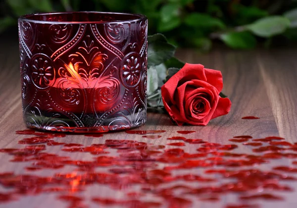 Red rose with candle and hearts stock images. Red romantic background. Red Valentine Day glitter background. Romantic still life with red rose and candle