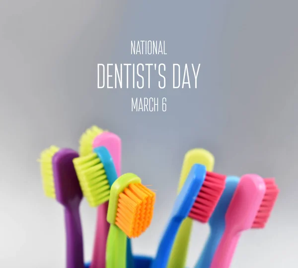 National Dentist\'s Day images. Colored toothbrushes stock images. Morning hygiene images. Bathroom accessories images. Toothbrush on a silver background. Dentists Day Poster, March 6. Important day