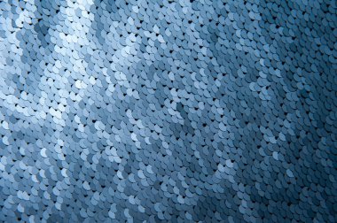 Mavi renk payetler yakın çekim makro arka plan doku. Pullu ile moda pahalı kumaş.