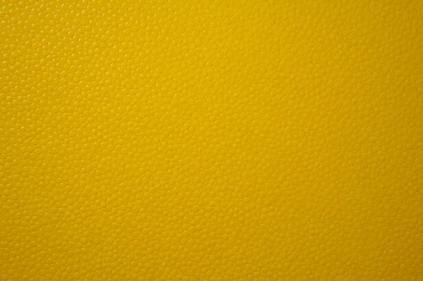 Texture of yellow paper for background. Textured with convex balls