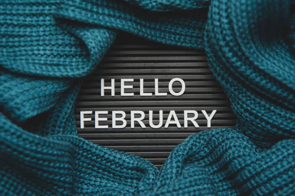 Hello February - text on a letter board with a knitted green-blu — Stock Photo, Image