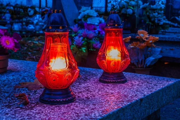 Colorful candles on cemetery at All Saints Day, Poland