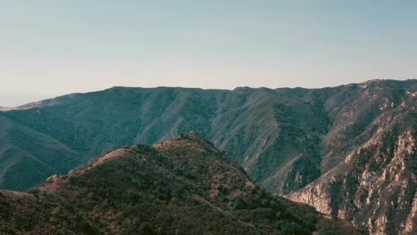 Cinema aerial panoramic video of the view of mountain formations in Malibu from a helicopter. Flying over the top of a mountain ridge. Los Angeles, California, USA — Stock Video