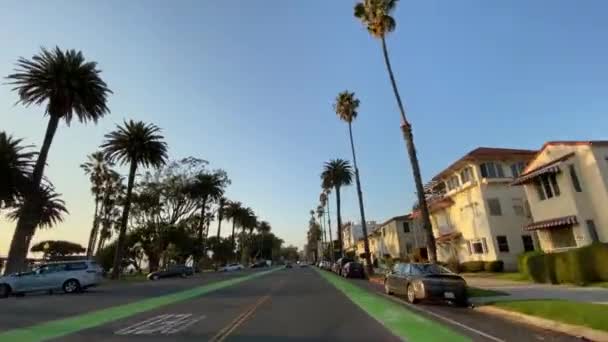 Santa Monica, Kalifornien, Usa - 15 december 2019: Kör bil på Santa Monica Ocean Ave vid solnedgången. Varm solig dag i Santa Monica Los Angeles Kalifornien Usa. — Stockvideo