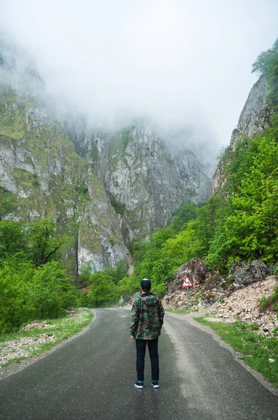 Young man walking on a mountains road