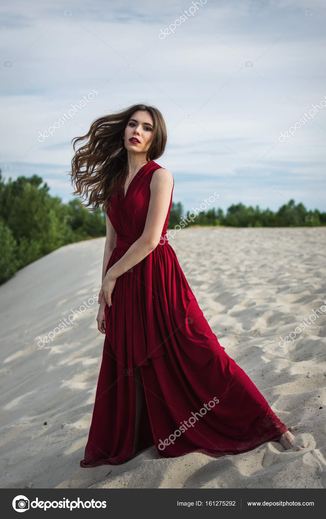 Beautiful girl in a red dress on the Concept of femininity - Main Image