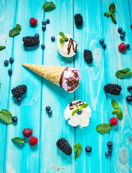Kopeček zmrzliny s čerstvým ovocem na modrém pozadí — Stock fotografie