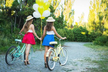İki şık genç kadın arkadaşlar bir bisiklet park. En yakın arkadaşlarım bir gün Bisiklet keyfi