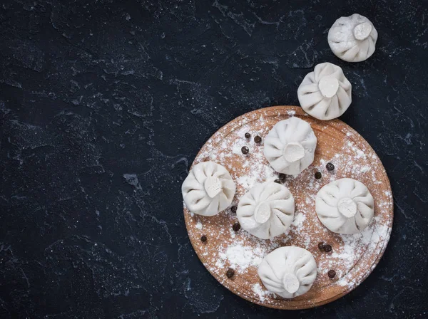 Pile of homemade raw khinkali dumplings close up on the stone rustic table. — Stock Photo, Image