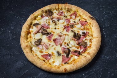 Pizza Carbonara siyah taş zemin üzerine. İtalyan Pizza Carbonara sosis, mantar ve peynir ile