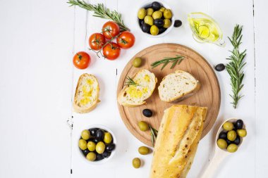 Ahşap kase ahşap beyaz zemin üzerine siyah ve yeşil zeytin.