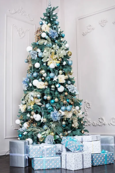 Altında hediyeler olan Noel ağacıyla süslenmiş güzel bir holdiay odası.
