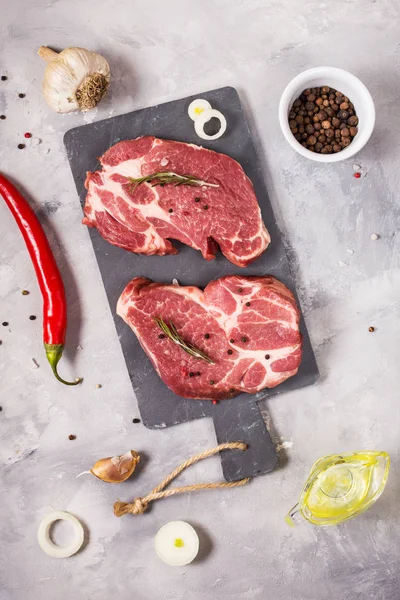 Filete de carne cruda con condimentos sobre fondo de hormigón. Filete listo para cocinar. Concepto de barbacoa. Ingredientes para el tostado de carne . —  Fotos de Stock