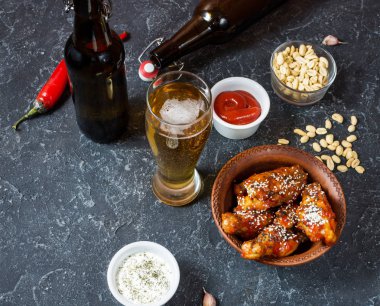 Bufalo stili tavuk kanatları soğuk birayla servis edilir.