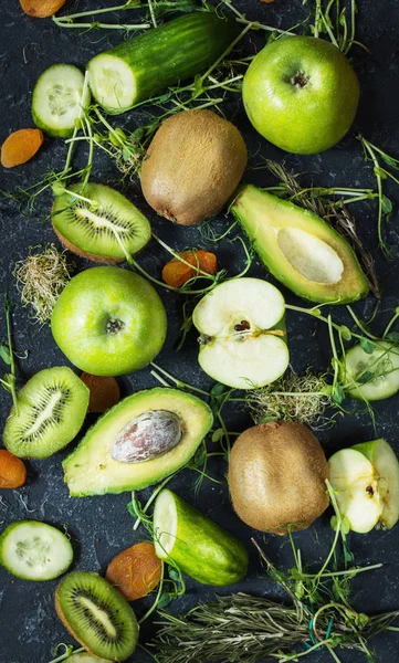 Ingrédients pour le smoothie de cuisine. Légumes et fruits verts biologiques sur fond de pierre noire. Pose plate — Photo