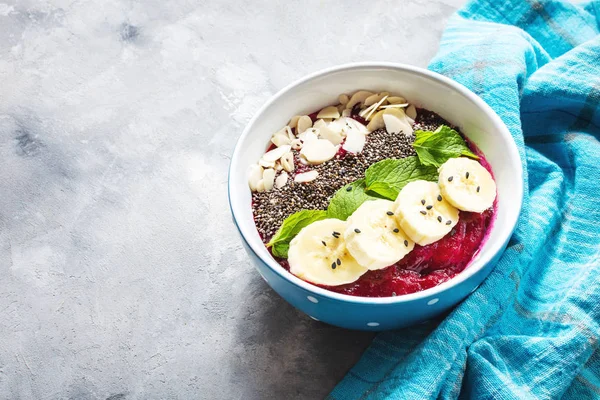 Healthy breakfast bowl - blueberry smoothie with banana, raspberry, almonds and chia seeds — Stock Photo, Image