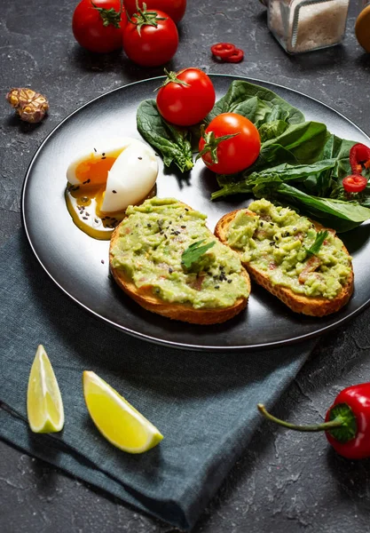 Avokado Meksika soslu avokado soslu sağlıklı tost haşlanmış yumurta, vişneli domates ve siyah taşlı salata. Kahvaltı.