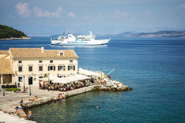 CORFU, GREECE - 10.09.2019 - Faliraki plajı Alecos hamamlarında Korfu Kasabası, İyon Denizi 'ndeki kaya ve iskele restoranı.