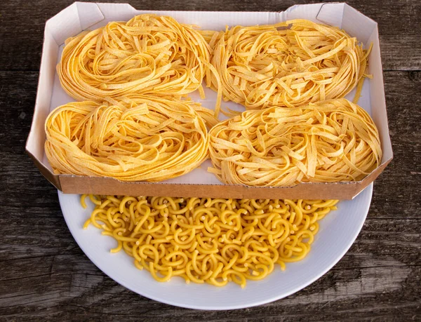 Droge Italiaanse pasta op houten ondergrond. Hoe pasta concept te koken — Stockfoto