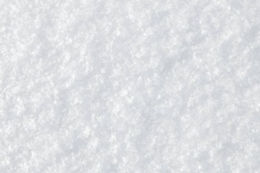 Taze karların arkaplanı beyaz kar taneleriyle kaplıdır.